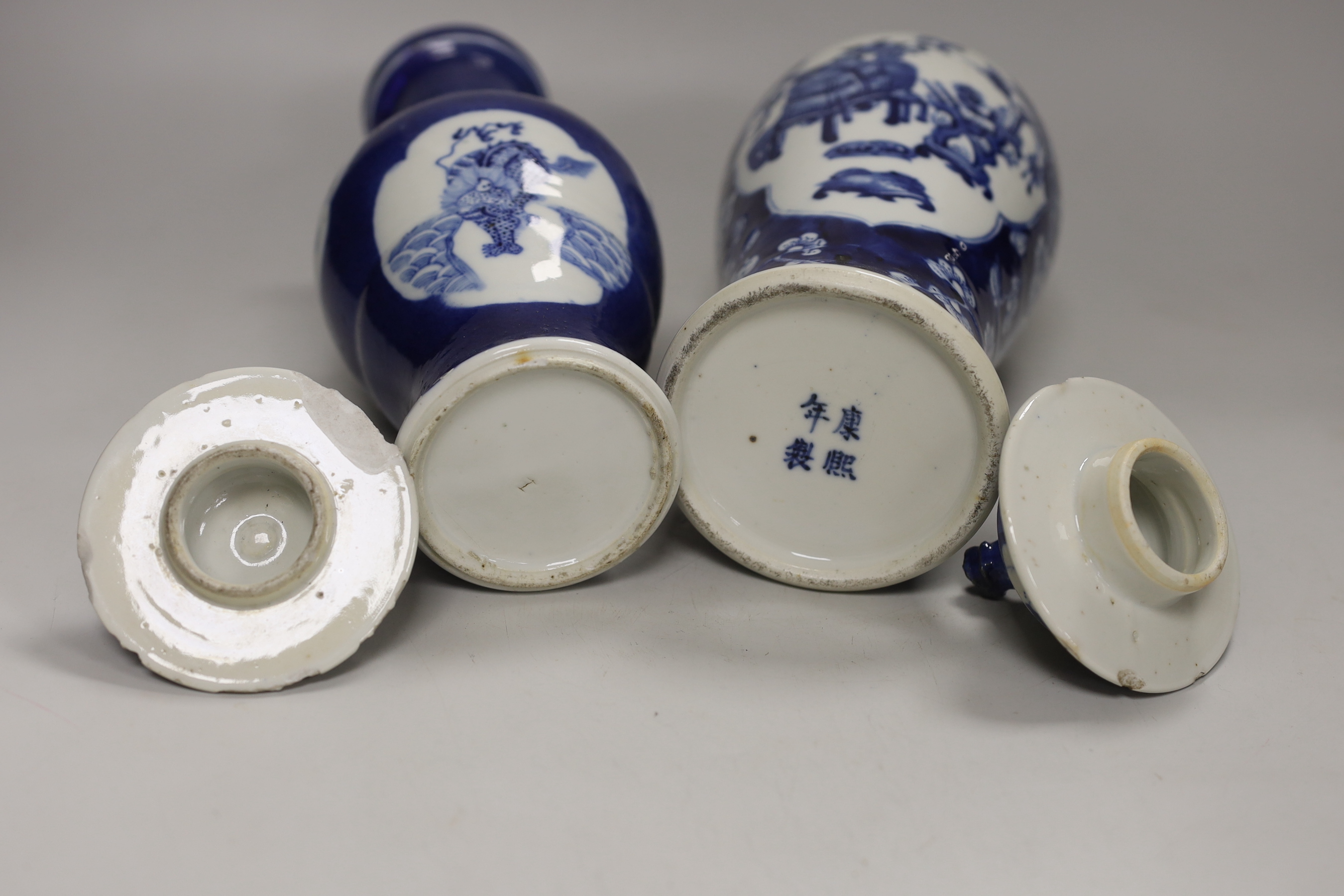 Two 19th century Chinese blue and white vases and covers, one with a dragon cartouche, the other a floral cartouche, tallest 34cm high